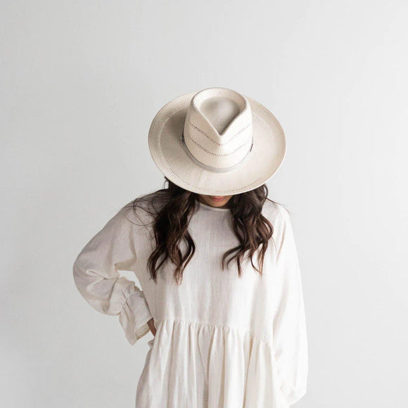 Arlo is an elevated straw fedora. Its teardrop crown + stiff upturned brim feature handwoven venting for a breezy feel + textured look. Arlo includes a hand-sewn leather band that is easily layered with other accessories. 